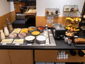 a counter with various food items on it in a kitchen at ibis Styles Macon Centre in Mâcon
