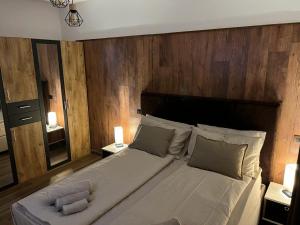 a bedroom with a large bed with a wooden wall at Rifugio Federici Home in Camigliatello Silano