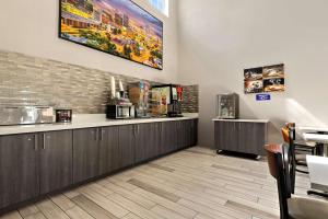 a waiting room at a restaurant with a counter at SureStay Plus Hotel by Best Western Tulsa East in Tulsa