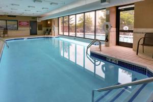 a large swimming pool with blue water in a building at Drury Inn & Suites Nashville Airport in Nashville