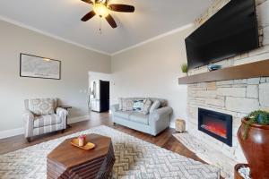 a living room with a fireplace and a flat screen tv at Norris Villa 2 in La Follette