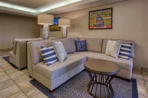 a living room with a couch and a table at Drury Inn & Suites St. Louis - Fairview Heights in Fairview Heights