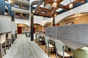 a dining area with tables and chairs in a building at Drury Plaza Hotel St. Paul Downtown in Saint Paul