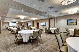 a conference room with tables and chairs and screens at Drury Plaza Hotel St. Paul Downtown in Saint Paul