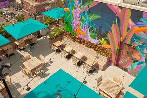 an overhead view of a patio with tables and chairs at Arlo Midtown in New York