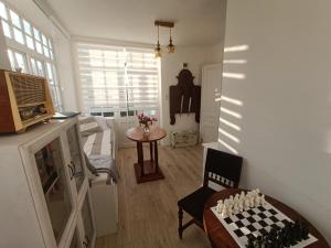 a living room with a chess board on a table at Tornácos Vendégház in Hajdúnánás