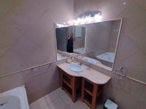 a person taking a picture in a bathroom mirror at La Pocilga in Paso de la Patria +9 photos