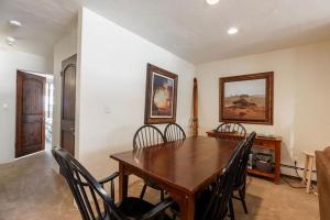 a dining room with a wooden table and chairs at Condos with Ski Locker and Vail Mountain Views in Vail