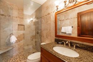 a bathroom with a sink and a toilet and a mirror at Condos with Ski Locker and Vail Mountain Views in Vail