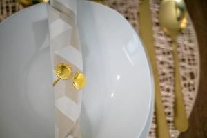a white tie with two gold rings on it at City Glow House in Ponta Delgada