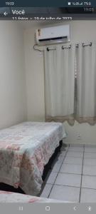 a bedroom with a bed with avertisement at Apartamento mobiliado - Centro Cuiabá in Cuiabá