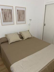 a bedroom with a large bed with two pillows at Apartamento Central Plaza in Puerto de la Cruz
