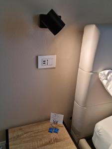a room with a bed and a clock on the wall at Alemanni54 - Apartment in Bologna +99 photos