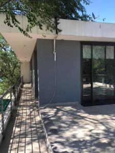 a house with a hose attached to the side of it at Boutique Casa en Comuna san Roque in San Roque