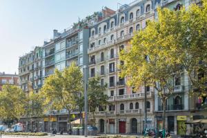 a large building on a city street with trees at 13PAR1004 - Fabulous apartment in the heart of Barcelona in Barcelona