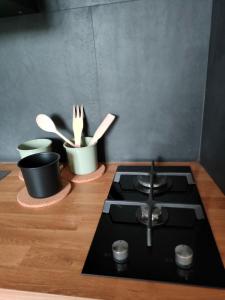 a kitchen with a stove and some knives and utensils at Molo27 CITRA 3979 in Genova