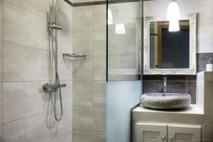 a bathroom with a sink and a shower with a mirror at Villa Art Foutia in Foútia +31 photos