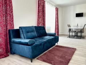 a blue couch in a living room with a table at Sky Apartments 501 in Pilsen