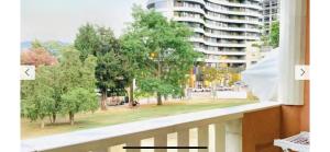 a window with a view of a park and a building at Monte Star apartments in Budva