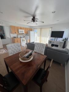 a living room with a table and a couch at Kailani Loft, Kailua Coconut Grove 1-bedroom in Kailua