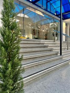 a christmas tree in front of a building with stairs at El Oscar Hotel in Medellín