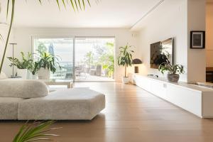 un soggiorno con divano e piante in vaso di Portopiccolo Designer Penthouse a Sistiana