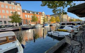 a group of boats docked in a canal with buildings at ApartmentInCopenhagen Apartment 510 in Copenhagen