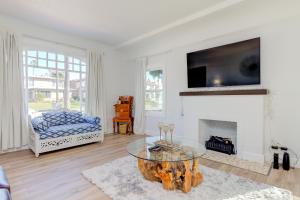 a living room with a fireplace and a tv at Lovely White Beach House in Redondo Beach