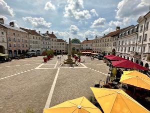 a courtyard with umbrellas in a city with buildings at Apt Place de Toscane - 4min Disneyland-PARIS in Serris +50 photos