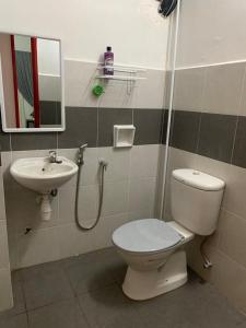 a bathroom with a toilet and a sink at ALEENA STAYCATION @ APARTMENT TOK PELAM PANTAI BATU BURUK in Kuala Terengganu