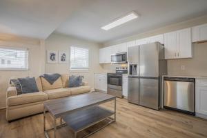 a kitchen with a couch and a table in a room at Cara's Cottage 2 miles from Sanford Stadium in Athens