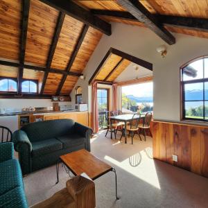 a living room with a couch and a table at Manapouri Holiday Park in Manapouri