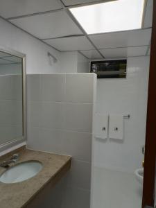 a white bathroom with a sink and a mirror at HOTEL PARQUE VIA in Mexico City