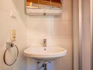 a bathroom with a white sink and a mirror at Appartement Brixnerwirt IV in Brixen im Thale