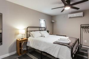 a bedroom with a bed with a ceiling fan at Greenway Garage with Firepit in Athens