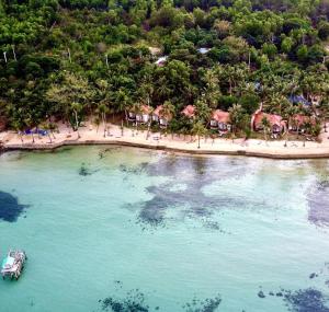 an aerial view of a beach with a boat in the water at Peppercorn Beach Resort in Phú Quốc