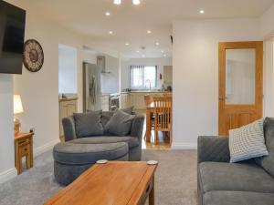 a living room with two couches and a table at Trinity Avenue Cottage in Bridlington