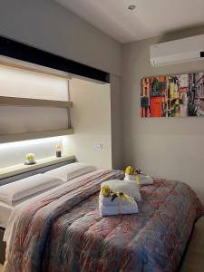 a bedroom with a bed with two pillows on it at BolognaBySide-DE FALEGNAMI in Bologna
