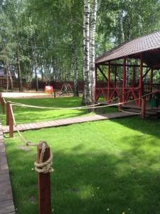 a park with a fence and a pavilion in the grass at Hotel Complex Dobriy Finn in Kazan