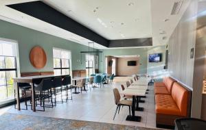 a waiting room at a hospital with tables and chairs at Comfort Suites in Cheyenne