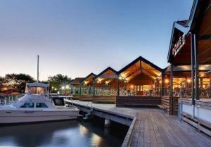 a boat docked at a marina with a building at Perth 2-Story, Views, BBQ & More in Perth