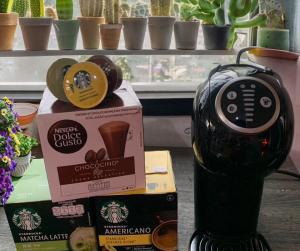 a coffee maker sitting next to a box of coffee at Happy Home Hostel in Lat Krabang