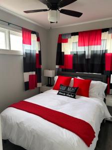 a bedroom with a large bed with red and black accents at Lake Shafer Resort in Monticello
