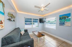 sala de estar con sofá y ventilador de techo en Blue Water Beachside Villa 1 en Clearwater Beach