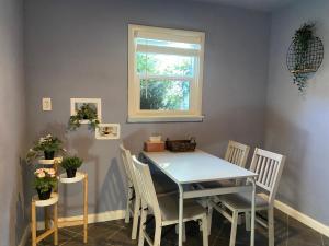 a dining room with a table and chairs and a window at Private House in Sacramento.Only 2mins to Freeway. in Sacramento