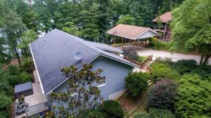 an aerial view of a house with a roof at Lakefront with Dock and Hot Tub! in Toccoa