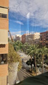 a view of a city with palm trees and buildings at Habitación en el Centro de Alicante in Alicante