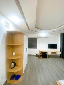 an empty room with a tv and a book shelf at Son Ca Motel in Hue