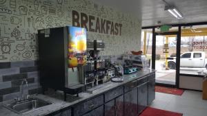 a kitchen with a coffee machine on a counter at Econo Lodge Oak Grove-Blue Springs in Oak Grove +29 photos