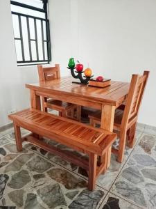 a wooden table and chairs with apples on top of it at Apartamento Estadio Laureles in Medellín